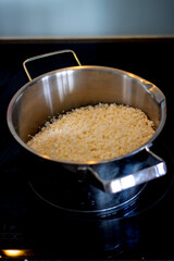 Cauliflower ground into small pieces using a blender in a steel pot.