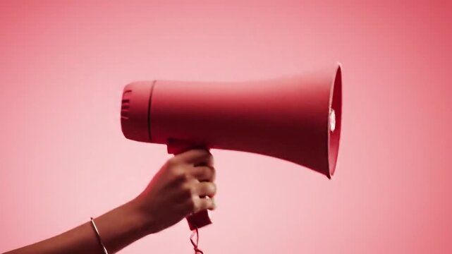 Person Holding Red Megaphone On Red Background Studio Shot