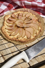 Freshly baked pear pie on a rack