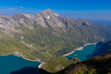 Fototapeta premium Mooserboden Staudamm in Austria beautiful alpine lakes stunning landscape. Austrian Alps in Salzburg Kaprun hiking trail scenic photo of two mountain lakes with turquoise water in the Alps from above