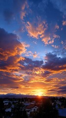 Dramatic Sunset Sky Over City and Mountains Orange Clouds.