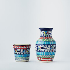 Two decorative ceramic vases isolated on white background, hand painted design