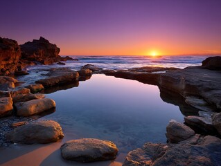 Sunset over Ocean with Tide Pool and Rocky Coastline.