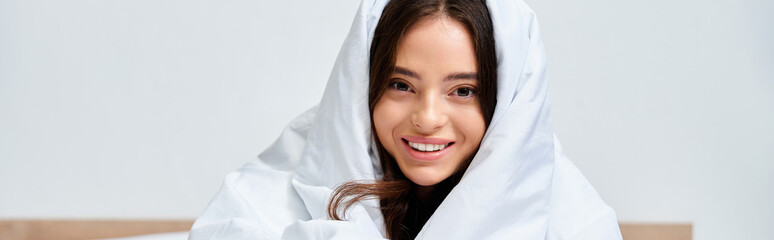 Warm moments of a beautiful young woman in her cozy bedroom enjoying quiet time