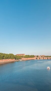 Panorama showing waterfront of Garonne River and Pont Neuf timelapse with Museum of the History of Medicine and ferris wheel in downtown Toulouse, France. Aerial view from Saint Pierre Bridge