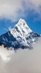 Majestic snow-capped mountain peak piercing clouds