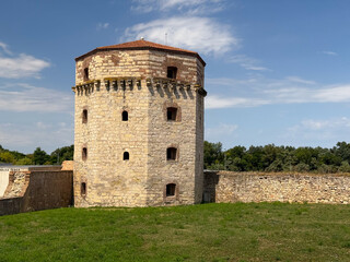 Obraz premium Nebojša tower of Belgrade Fortress with historic stone walls and green surroundings under summer sky. Cultural heritage, medieval fortification, history, architecture, tradition, landmark and