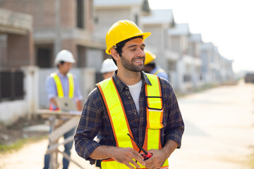 Portrait Hispanic male engineer : Architect, contractor and architecture standing in house building under construction site. Engineering in safety harthat helmet, Professional engineering teamwork