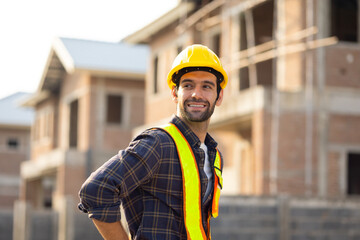 Portrait Hispanic male engineer : Architect, contractor and architecture standing in house building under construction site. Engineering in safety harthat helmet, Professional engineering teamwork