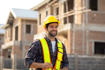 Portrait Hispanic male engineer : Architect, contractor and architecture standing in house building under construction site. Engineering in safety harthat helmet, Professional engineering teamwork