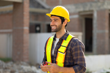 Portrait Hispanic male engineer : Architect, contractor and architecture standing in house building under construction site. Engineering in safety harthat helmet, Professional engineering teamwork
