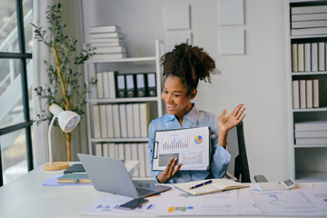 Young african american businesswoman showing charts and graphs during video call