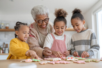 grandmother and her grandchildren are joyfully decorating gingerbread cookies together