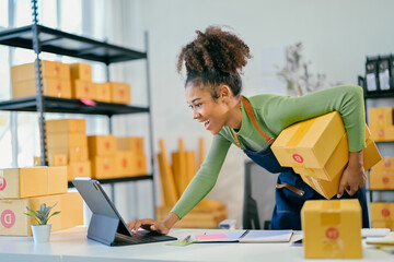 Young african american woman managing online orders in warehouse