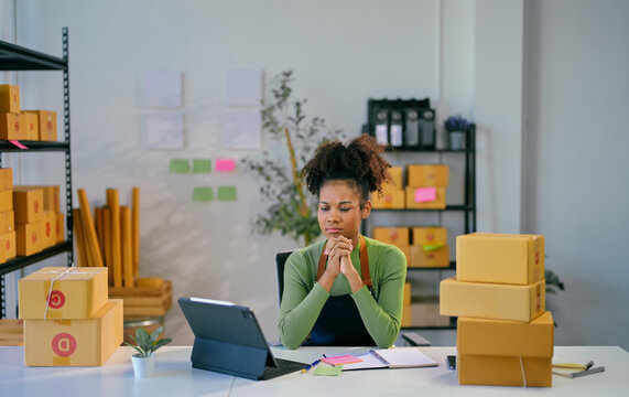 Young african american woman entrepreneur managing her online business from home office