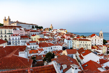 Lisbon Alfama rooftops with historic churches at twilight