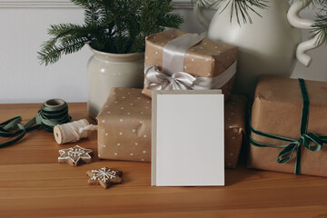 Cozy Christmas scene with wrapped gifts in brown paper, festive ribbons, star gingerbread cookies....