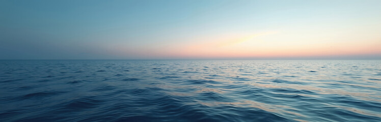 Fototapeta premium Calm ocean horizon at dusk with gentle waves. The clear sky shows soft colors from the setting sun. Tranquil seascape offers a sense of peace and serenity, perfect for relaxation or travel themes.