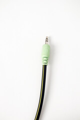 Close-up of a Green Audio Cable Connector on a White Background for Sound Transmission