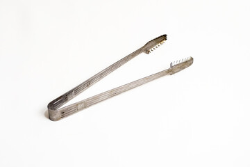 A simple studio shot of ice tongs on a white background, highlighting the tool's design