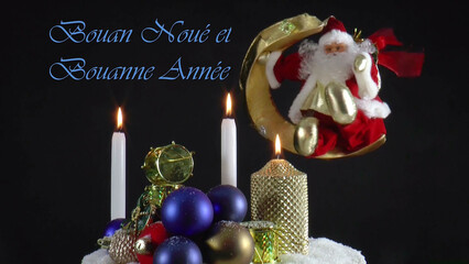 Warm Wishes for Christmas Joy 
A festive card with candles, baubles, and Santa Claus in the language Jèrriais 
