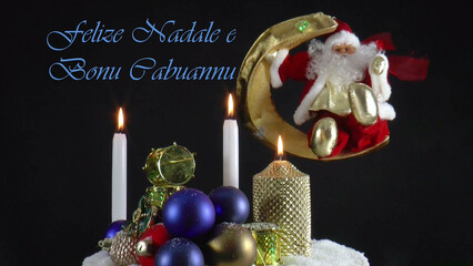 Warm Wishes for Christmas Joy 
A festive card with candles, baubles, and Santa Claus in the language Sardian
