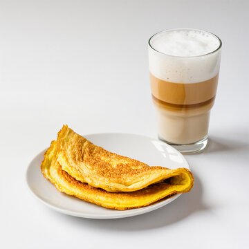 Delicious golden omelet with a creamy latte in a cozy setting
