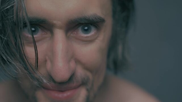 Large Eyes and Long Hair: Intense Expressions of a Young Beautiful Slavic Man with White Skin in Soft Lighting