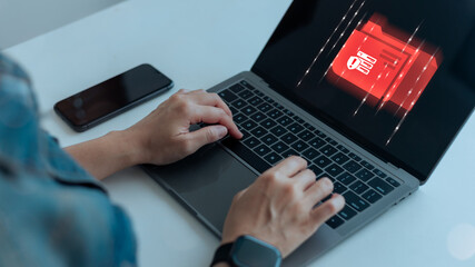 Close up of a person typing on a laptop with a red warning folder icon on screen, cybersecurity threat, data breach, malware attack, and hacking alert concept for online business security.
