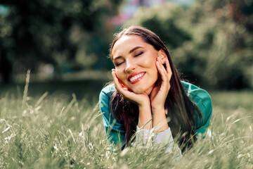 Adorable woman enjoying outdoor leisure in an urban park during a sunny day, radiating happiness...