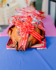 Roast pig with red ribbon decoration for Vietnamese wedding ceremony