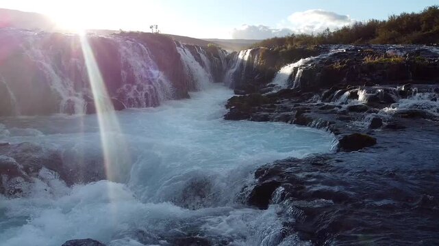 Low Angle Drone Over Br&uacute;arfoss Waterfall Sun Flare Pan