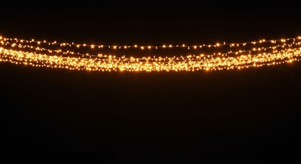 Glowing string lights against a dark background for festive or decorative design elements