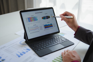 Businessman analyzing financial data on digital tablet with graphs and charts