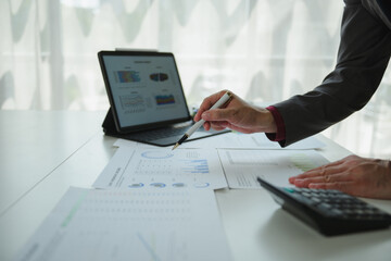 Businessman analyzing financial charts and graphs using modern technology