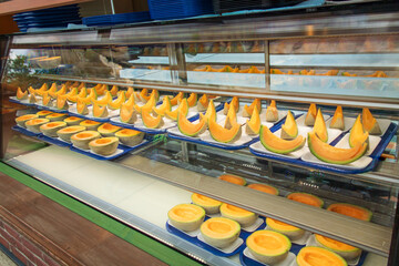 Cantaloupe Composition: Fresh Melon Display in Bright Retail Case