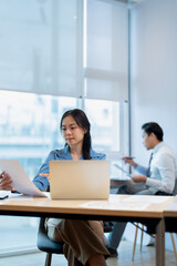 Two colleagues working analytic in office