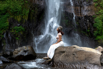 Woman at Gitgit waterfall in Bali , Singaraja, Indonesia
