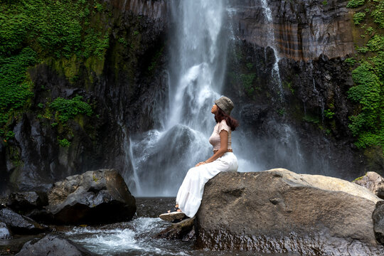 Woman at Gitgit waterfall in Bali , Singaraja, Indonesia