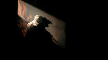 A person is standing in a dark room