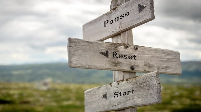 Wooden sign on a mountain plateau with the quote "Pause Reset Start", surrounded by serene alpine scenery and soft sunlight, evoking mindfulness, reflection, and new beginnings.