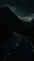 Dark winding road through mountains.