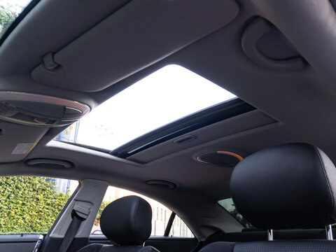 Mercedes-Benz CLS 63 AMG interior with open sunroof, Luxury sedan cabin view

