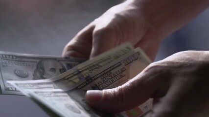 Recalculation of Money Manual. Paper banknotes slowly translated by hand on blurred background. Slow Motion - Powered by Adobe