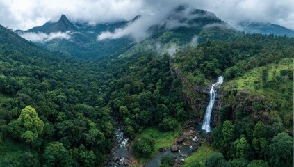 Panoramic view of a lush valley with a waterfall cascading down a cliff face