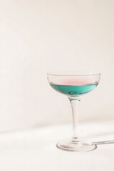 A vibrant cocktail in a stemmed glass, featuring a blend of pink and blue hues, set against a clean, minimalist background.