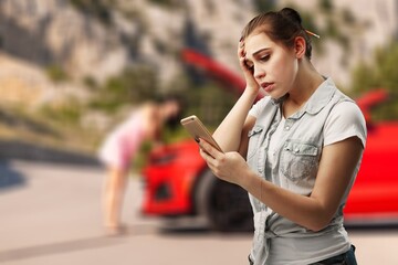 Sad woman with broken car on roadside, searching for help.