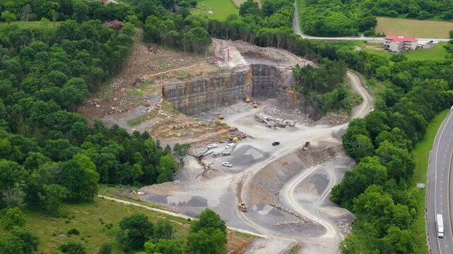 Industrial open-pit mining site with limestone quarry at mountain hillside