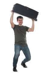 Furious and irritated young man traveler lifting and throwing away his travel luggage. Displeased guy has issues with his baggage, full length portrait isolated on transparent background