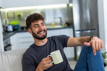Young man enjoying morning coffee in his cozy home